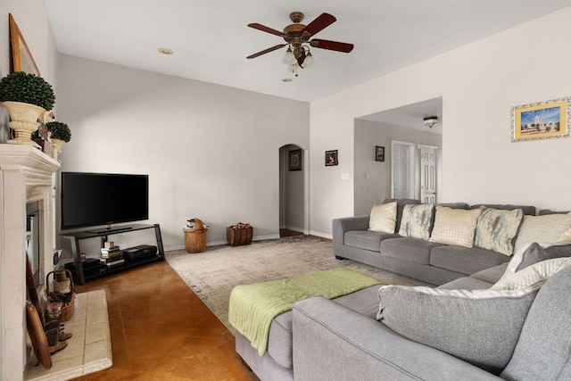 251 Barton Meadow Dr, Dripping Springs, TX 78620 - living room with arched walkways, a ceiling fan, and a fireplace