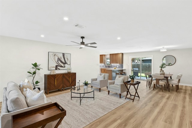 1806 Teton Dr, Austin, TX 78757 - living room with light wood finished floors, recessed lighting, and a ceiling fan