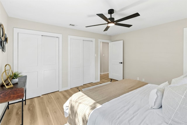 1806 Teton Dr, Austin, TX 78757 - bedroom featuring two closets, light wood-style flooring, and ceiling fan