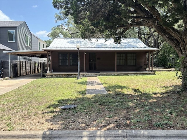 2503 S 4th St, Austin, TX 78704 - view of front of house with covered porch, driveway, a carport, a metal roof, and a standing seam roof
