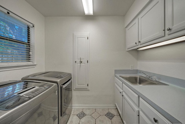 13109, 13111 Mansfield Dr Dr, Austin, TX 78732 - washroom featuring independent washer and dryer, cabinet space, and light tile patterned flooring