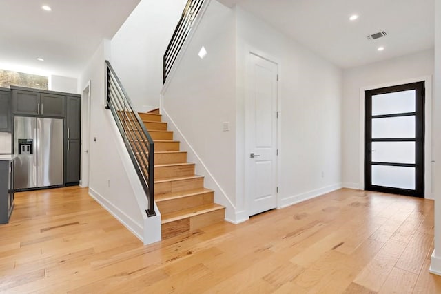 1719 Bunche Rd, Austin, TX 78721 - entryway with stairs, light wood-style flooring, and recessed lighting