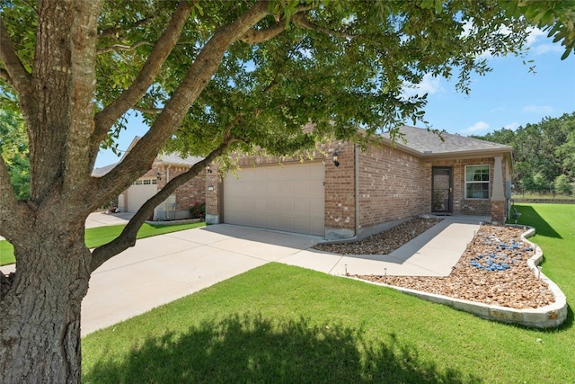 225 Hobby St, Georgetown, TX 78633 - view of front of home with brick siding, an attached garage, concrete driveway, and a front lawn