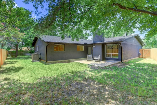 10206 Cripple Creek Cv, Austin, TX 78758 - rear view of house featuring brick siding, a chimney, a patio area, and a fenced backyard