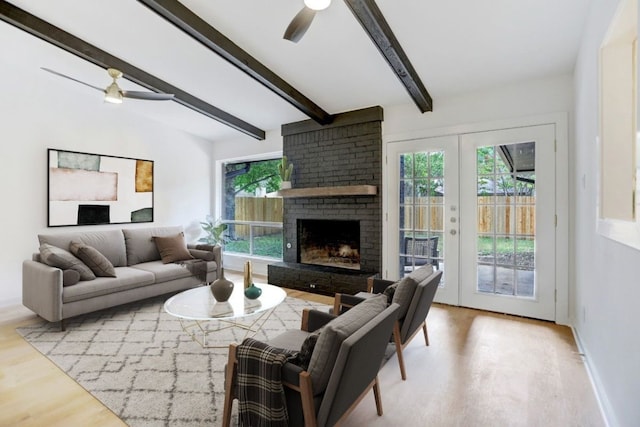 10206 Cripple Creek Cv, Austin, TX 78758 - living area featuring ceiling fan, healthy amount of natural light, wood finished floors, beamed ceiling, and a fireplace