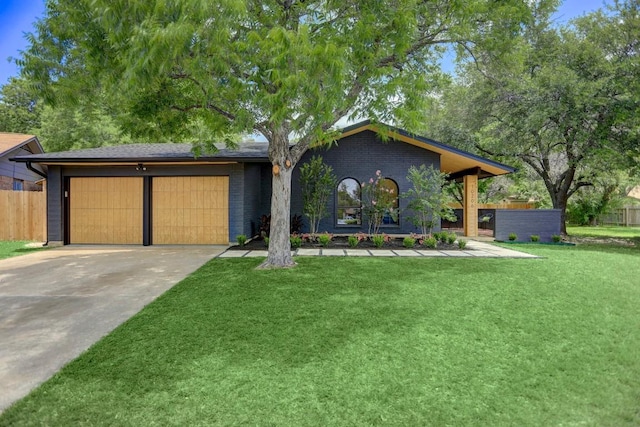 10206 Cripple Creek Cv, Austin, TX 78758 - view of front facade featuring a garage, driveway, and brick siding