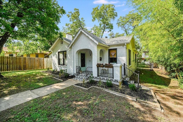 510 E 38th St, Austin, TX 78705 - view of front of house featuring a porch, brick siding, and a chimney