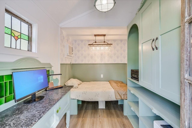 510 E 38th St, Austin, TX 78705 - bedroom with wood finished floors, vaulted ceiling, wallpapered walls, and arched walkways