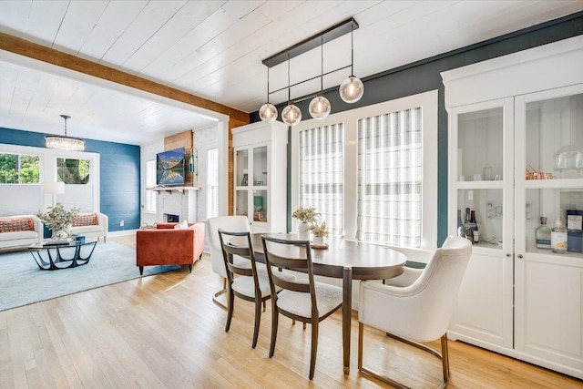 510 E 38th St, Austin, TX 78705 - dining area featuring light wood-style floors, a chandelier, and a wood ceiling with exposed beams