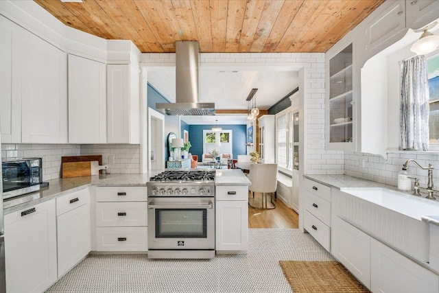 510 E 38th St, Austin, TX 78705 - kitchen featuring stainless steel appliances, wooden ceiling, range hood, tasteful backsplash, and white cabinetry