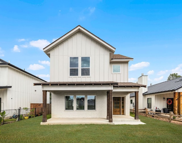 182 W Torrey St, New Braunfels, TX 78130 - rear view of property with board and batten siding, a patio area, and brick siding