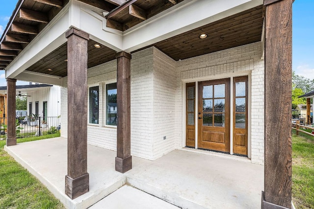 182 W Torrey St, New Braunfels, TX 78130 - view of exterior entry featuring brick siding and a patio