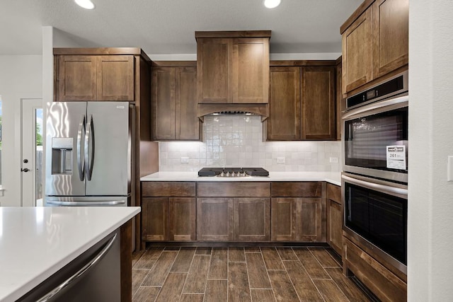 182 W Torrey St, New Braunfels, TX 78130 - kitchen with stainless steel appliances, light countertops, tasteful backsplash, wood tiled floors, and recessed lighting