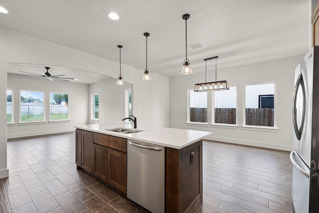 182 W Torrey St, New Braunfels, TX 78130 - kitchen with stainless steel appliances, open floor plan, light countertops, a ceiling fan, and wood finish floors