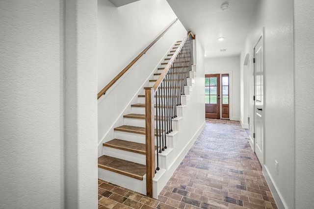 182 W Torrey St, New Braunfels, TX 78130 - staircase featuring french doors, brick patterned flooring, and recessed lighting