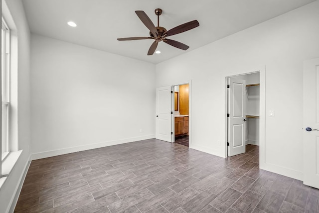 182 W Torrey St, New Braunfels, TX 78130 - unfurnished bedroom featuring dark wood-type flooring, a walk in closet, recessed lighting, ensuite bathroom, and a ceiling fan