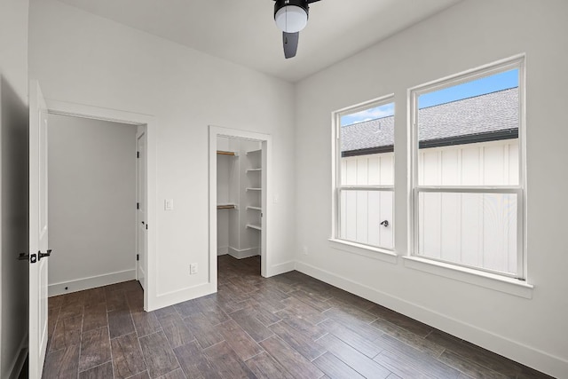 182 W Torrey St, New Braunfels, TX 78130 - unfurnished bedroom featuring dark wood-type flooring, a walk in closet, a closet, and ceiling fan