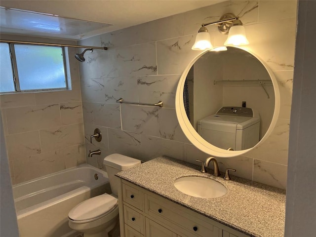 1015 E Yager Ln Unit 77, Austin, TX 78753 - bathroom with tile walls, vanity, bathtub / shower combination, and washer / clothes dryer