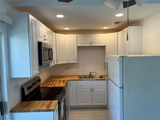 1015 E Yager Ln Unit 77, Austin, TX 78753 - kitchen featuring stainless steel appliances, butcher block counters, a ceiling fan, white cabinets, and recessed lighting