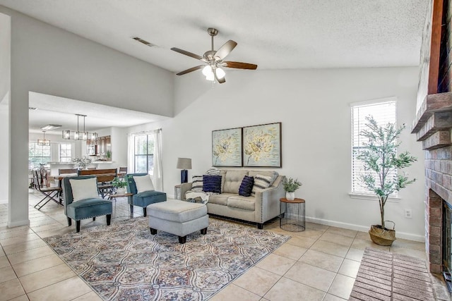 17516 Klamath Falls Dr, Round Rock, TX 78681 - living room featuring a fireplace, tile patterned floors, a ceiling fan, lofted ceiling, and a textured ceiling