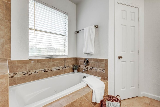 17516 Klamath Falls Dr, Round Rock, TX 78681 - bathroom featuring a tub with jets, plenty of natural light, and tile patterned floors