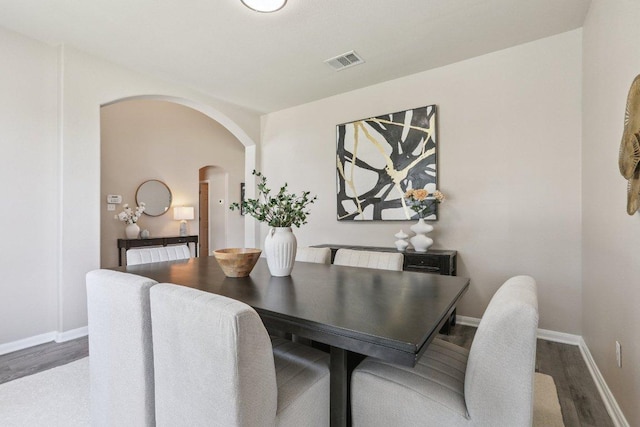 212 Boone Valley Dr, Round Rock, TX 78664 - dining area with arched walkways and wood finished floors