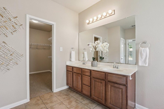 212 Boone Valley Dr, Round Rock, TX 78664 - full bathroom featuring double vanity, tile patterned flooring, and a spacious closet