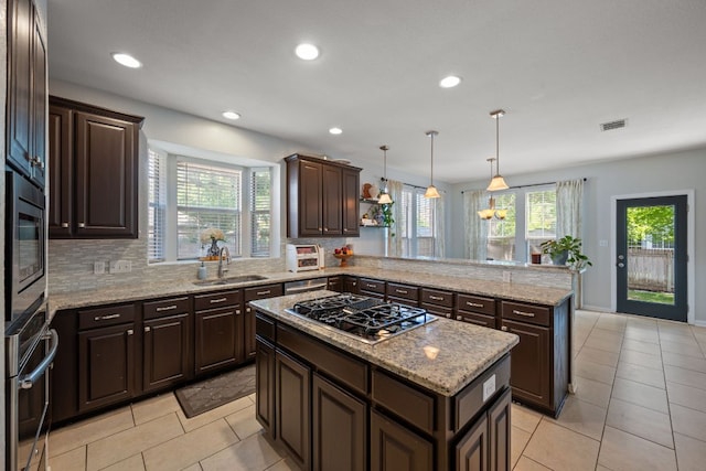 16210 Braesgate Dr, Austin, TX 78717 - kitchen with stainless steel appliances, a peninsula, dark brown cabinets, light tile patterned floors, and recessed lighting