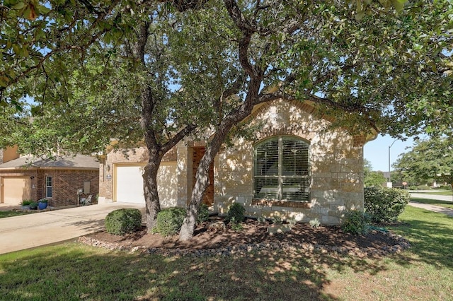 1200 Falling Hills Dr, Georgetown, TX 78628 - view of property hidden behind natural elements with driveway, a garage, and brick siding