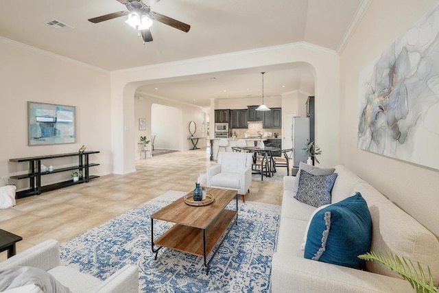 1200 Falling Hills Dr, Georgetown, TX 78628 - living room with arched walkways, a ceiling fan, ornamental molding, and light tile patterned floors
