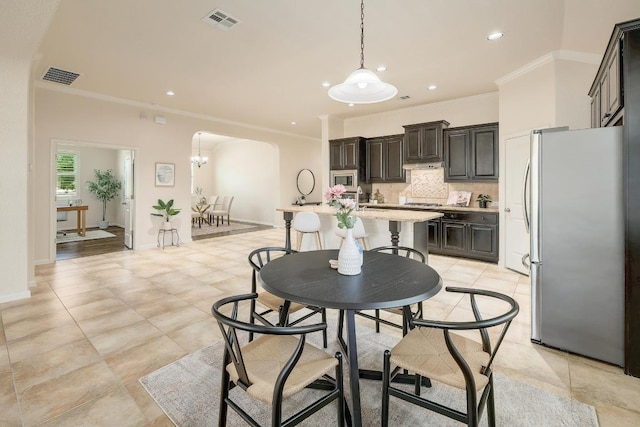 1200 Falling Hills Dr, Georgetown, TX 78628 - dining area with ornamental molding, arched walkways, recessed lighting, and light tile patterned flooring