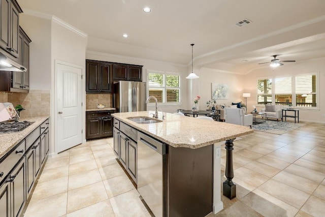 1200 Falling Hills Dr, Georgetown, TX 78628 - kitchen with appliances with stainless steel finishes, backsplash, open floor plan, a kitchen breakfast bar, and a ceiling fan