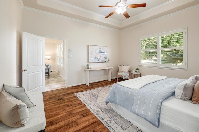 1200 Falling Hills Dr, Georgetown, TX 78628 - bedroom with a tray ceiling, crown molding, wood finished floors, and a ceiling fan