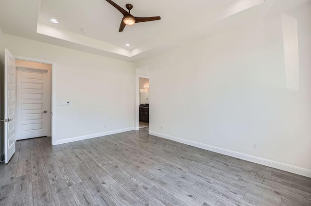 520 Germander Rd, Leander, TX 78641 - spare room with a ceiling fan, wood finished floors, a tray ceiling, and recessed lighting
