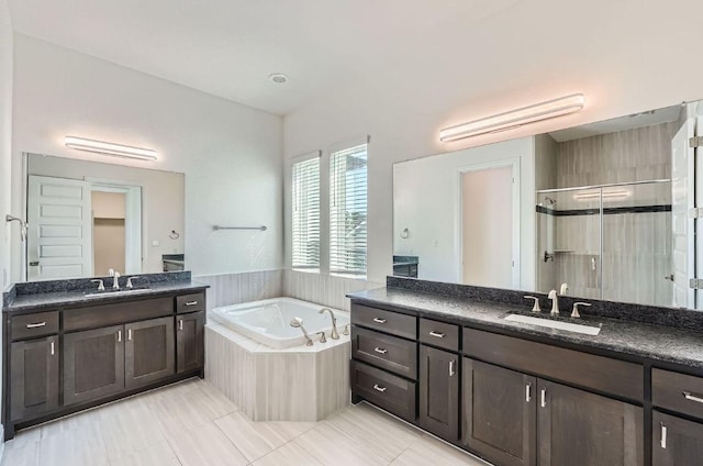 520 Germander Rd, Leander, TX 78641 - bathroom featuring a shower stall, a garden tub, two vanities, and tile patterned flooring