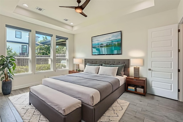 520 Germander Rd, Leander, TX 78641 - bedroom with a raised ceiling, light wood-style floors, a ceiling fan, and recessed lighting
