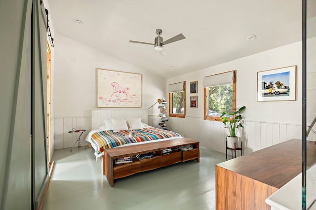 5204 Cueva Dr, Austin, TX 78738 - bedroom with wainscoting, vaulted ceiling, a ceiling fan, and finished concrete floors