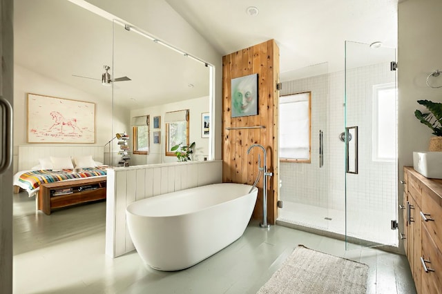5204 Cueva Dr, Austin, TX 78738 - full bath featuring a shower stall, a freestanding tub, vanity, and vaulted ceiling