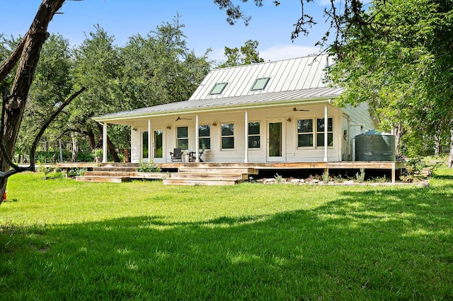5204 Cueva Dr, Austin, TX 78738 - rear view of house with ceiling fan, a lawn, and a metal roof