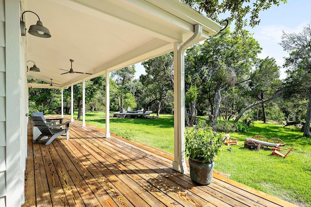 5204 Cueva Dr, Austin, TX 78738 - wooden terrace featuring a lawn, view of wooded area, ceiling fan, and a fire pit