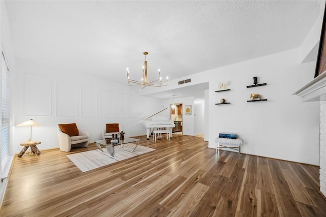 7162 Chimney Cors Unit 7204, Austin, TX 78731 - sitting room with a chandelier and wood finished floors
