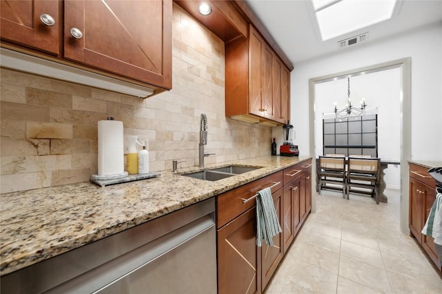 7162 Chimney Cors Unit 7204, Austin, TX 78731 - kitchen with decorative backsplash, a chandelier, light stone counters, and light tile patterned floors