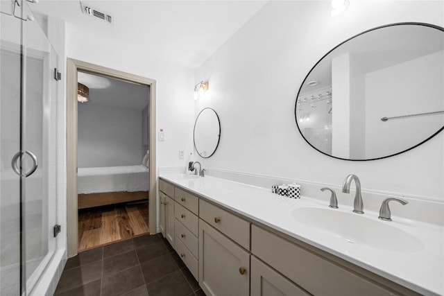 7162 Chimney Cors Unit 7204, Austin, TX 78731 - ensuite bathroom with a shower stall, double vanity, and tile patterned floors