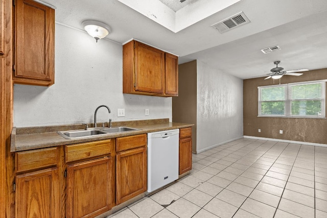 1703 Greyson Dr, Round Rock, TX 78664 - kitchen featuring dishwasher, brown cabinetry, ceiling fan, and light tile patterned floors