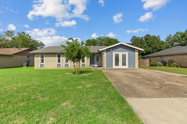 1703 Greyson Dr, Round Rock, TX 78664 - single story home with french doors, brick siding, and concrete driveway