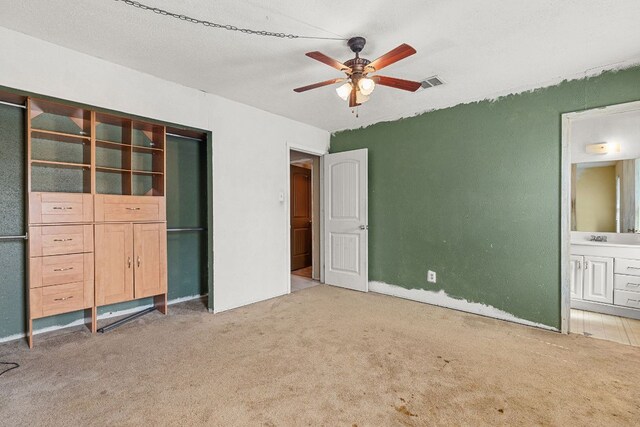 1703 Greyson Dr, Round Rock, TX 78664 - unfurnished bedroom with light colored carpet, ensuite bathroom, and ceiling fan
