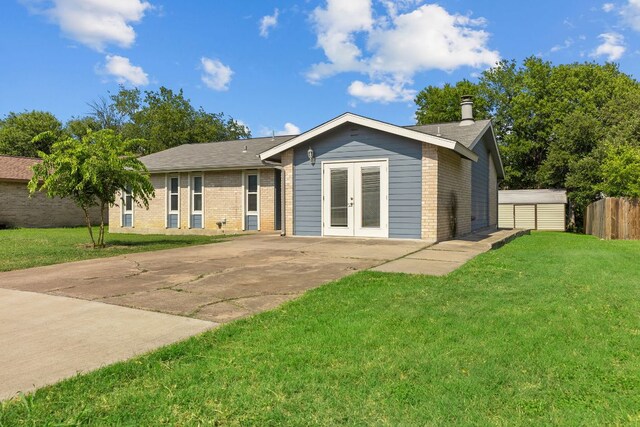 1703 Greyson Dr, Round Rock, TX 78664 - back of property featuring brick siding, french doors, and concrete driveway