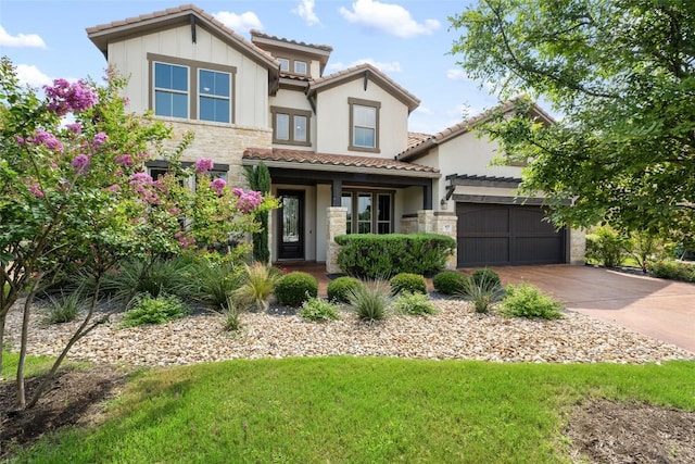 105 Curacao Ct, Austin, TX 78738 - view of front facade featuring stone siding, a tiled roof, and concrete driveway
