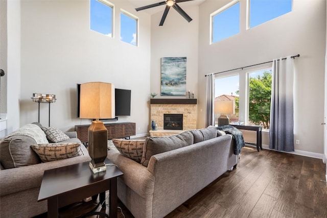 105 Curacao Ct, Austin, TX 78738 - living area featuring a towering ceiling, dark wood-style floors, plenty of natural light, and a stone fireplace