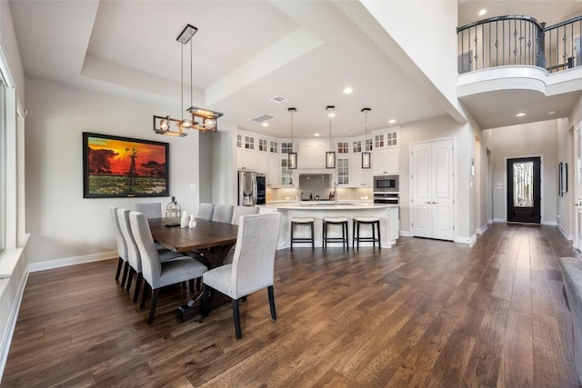 105 Curacao Ct, Austin, TX 78738 - dining space with dark wood-type flooring, a chandelier, and recessed lighting